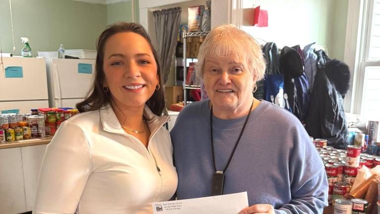Shannen Borris oPeople Helping People presents a check to Nancy Potter of the Ecumenical Food Pantry of Pike County.