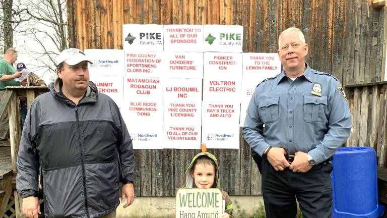 James Leiser, volunteer; Jason Montana, grand prize winner; and Pike County Sheriff Brian M. Vennie encourage kids to enter this year’s Fishing Derby.