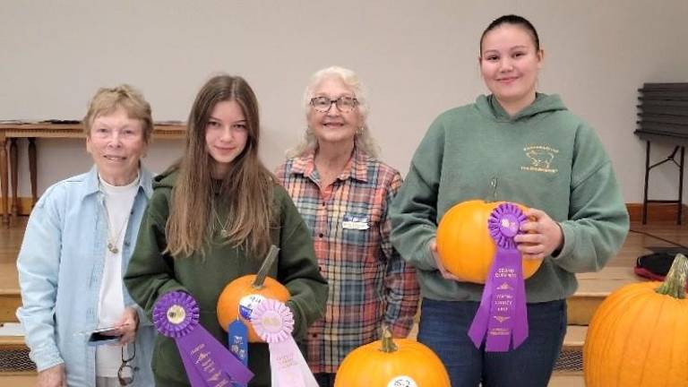 Master Gardener Mary Fenton, Truly Zablocky (Bethnay 4-H Club) with her Reserve Grand Champion pumpkin, Master Gardener Wanda Eisenhauer, and Channing Rutledge (Tri-Gal 4-H Club) with her Grand Champion Pumpkin.